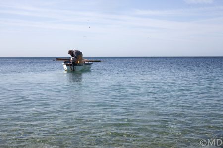 Local pot fisherman preparing boat at Chesil Cove, Dorset, UK